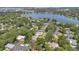 Panoramic aerial view featuring lush green neighborhoods, a scenic lake, and a distant cityscape skyline at 3332 Stonewood Ct, Orlando, FL 32806