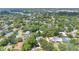 Aerial view showcasing a tranquil residential area with lush green trees and serene lake in the background at 3332 Stonewood Ct, Orlando, FL 32806