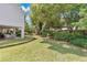 Large backyard features green lawn, landscaped garden beds, covered patio and mature trees at 3332 Stonewood Ct, Orlando, FL 32806