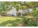 Back yard with landscaped gardens, mature trees, covered patio and fenced perimeter at 3332 Stonewood Ct, Orlando, FL 32806