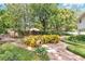 Backyard garden with stone walkway, decorative plants, mature trees and privacy fence at 3332 Stonewood Ct, Orlando, FL 32806