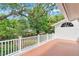 Bright terrace is surrounded by lush trees and a blue sky at 3332 Stonewood Ct, Orlando, FL 32806