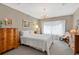 Cozy bedroom featuring carpet, classic decor, and a large window with decorative drapes at 3332 Stonewood Ct, Orlando, FL 32806