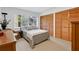 Bedroom with a queen bed, a large window, and built-in wood closets at 3332 Stonewood Ct, Orlando, FL 32806