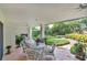 Covered patio with tile flooring, white wicker furniture, ceiling fan and views of the landscaped yard at 3332 Stonewood Ct, Orlando, FL 32806