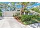 Charming two-story home featuring a well-manicured lawn, mature trees, and a large front yard with beautiful landscaping at 3332 Stonewood Ct, Orlando, FL 32806
