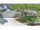 Beautiful home featuring mature trees, manicured lawn, well-maintained landscaping, and a two-car garage at 3332 Stonewood Ct, Orlando, FL 32806