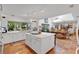 Bright kitchen with an island, white cabinetry, and an adjacent dining area, perfect for culinary creations and gatherings at 3332 Stonewood Ct, Orlando, FL 32806