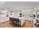 Bright kitchen features white cabinetry, central island with breakfast bar, and terracotta tile flooring at 3332 Stonewood Ct, Orlando, FL 32806
