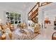 Bright living room with vaulted ceilings, tile floors, and a large window offering a view of the landscaped yard at 3332 Stonewood Ct, Orlando, FL 32806