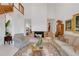 Open living room featuring a fireplace, tall ceilings, and elegant furnishings, creating a cozy and inviting atmosphere at 3332 Stonewood Ct, Orlando, FL 32806