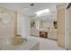 Spacious main bathroom with a large soaking tub, vanity, and tile flooring at 3332 Stonewood Ct, Orlando, FL 32806
