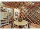 Wine cellar with diamond wine rack, terra cotta tile floor, and table under a unique coffered ceiling and stairway at 3332 Stonewood Ct, Orlando, FL 32806