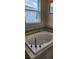 Close-up of bathtub with a relaxing faucet with window nearby at 3998 Bedford Ave, Winter Haven, FL 33884