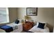 Cozy bedroom featuring two twin beds with quaint decor, perfect for children or guests at 3998 Bedford Ave, Winter Haven, FL 33884