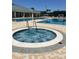 Community hot tub, poolside seating, and swimming pool create a relaxing oasis at 3998 Bedford Ave, Winter Haven, FL 33884