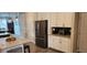 Contemporary kitchen featuring stainless steel appliances, dark backsplash, and white cabinets at 3998 Bedford Ave, Winter Haven, FL 33884