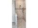 Tiled walk-in shower with built-in shelves offering storage at 3998 Bedford Ave, Winter Haven, FL 33884