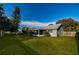 Well-maintained backyard with a lush lawn, mature trees, and a screened-in patio, perfect for outdoor enjoyment at 4012 King Edward Dr, Orlando, FL 32826