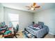 Cozy bedroom with carpet, ceiling fan, and natural light, providing a comfortable space at 4012 King Edward Dr, Orlando, FL 32826