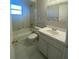Bright bathroom featuring a tub/shower, vanity, and neutral tile at 403 Short Dr, Poinciana, FL 34759