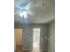 Comfortable bedroom featuring ceiling fan, neutral walls and a closet at 403 Short Dr, Poinciana, FL 34759