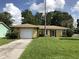 Charming single Gathering home with attached garage and inviting landscaping at 403 Short Dr, Poinciana, FL 34759
