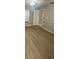 Spacious living room featuring new wood-look flooring and natural light at 403 Short Dr, Poinciana, FL 34759