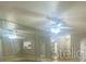 Bright living room featuring a ceiling fan and mirrored walls at 403 Short Dr, Poinciana, FL 34759