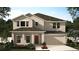 Charming two-story home featuring an attached garage and a well-manicured front lawn, perfect for Gathering living at 4066 Serene Water Ave, Eustis, FL 32736