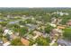 Neighborhood aerial view with a pond and homes amongst lush green trees at 4119 Pecan Ln, Orlando, FL 32812