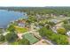 Aerial view showcases homes near a lake, lush trees, and community amenities at 4119 Pecan Ln, Orlando, FL 32812