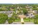 An aerial view shows a well-maintained home in a neighborhood with mature trees at 4119 Pecan Ln, Orlando, FL 32812