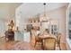 Open dining area with a chandelier, light walls, and views into the kitchen and to the outdoors at 4119 Pecan Ln, Orlando, FL 32812