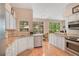 Bright kitchen with stainless steel appliances, granite countertops and breakfast nook overlooking the lanai at 4119 Pecan Ln, Orlando, FL 32812