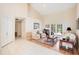 Inviting living room with neutral walls, tile and wood floors, with double doors to the outside at 4119 Pecan Ln, Orlando, FL 32812