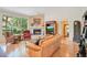 Comfortable living room features stone fireplace, large windows, wood floors, and vaulted ceiling at 4119 Pecan Ln, Orlando, FL 32812