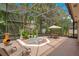 Screened-in patio with spa and lush landscaping, perfect for outdoor dining and enjoying the scenery at 4119 Pecan Ln, Orlando, FL 32812