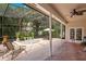 Enclosed patio featuring a spa, lush greenery, and lounge chairs for relaxation and outdoor enjoyment at 4119 Pecan Ln, Orlando, FL 32812