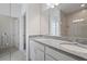 Bright bathroom featuring a granite-look countertop with double sinks and a glass enclosed shower at 451 Shadow Gorge Way, Eustis, FL 32736