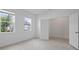 Bright bedroom with tile flooring, large windows and closet with white door at 451 Shadow Gorge Way, Eustis, FL 32736