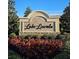 Elegant Lake Lincoln community entrance sign with beautiful landscaping and well-maintained flower beds at 451 Shadow Gorge Way, Eustis, FL 32736