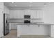 Modern kitchen featuring stainless steel appliances, granite countertops, and ample cabinet space at 451 Shadow Gorge Way, Eustis, FL 32736