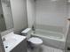 An all-white bathroom featuring a shower-tub combo with white tile, a toilet, and a vanity at 4617 Frisco Cir, Orlando, FL 32808