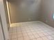 Bedroom featuring gray walls, ceramic tile flooring, a window, and a white door at 4617 Frisco Cir, Orlando, FL 32808