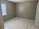 This bedroom has tile flooring, gray walls, and a single window at 4617 Frisco Cir, Orlando, FL 32808