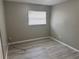 Bedroom with gray walls, blinds and wood grain-style flooring at 4617 Frisco Cir, Orlando, FL 32808