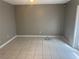 This living room has tile flooring, gray walls, and a ceiling fan at 4617 Frisco Cir, Orlando, FL 32808