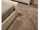 Bedroom detail shows a modern bed frame and neutral carpet for a calm atmosphere at 4762 Sparkling Shell Ave, Kissimmee, FL 34746