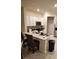 Kitchen with white cabinets, stainless steel appliances, and a quartz countertop island with seating at 4762 Sparkling Shell Ave, Kissimmee, FL 34746